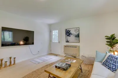 a living room with a couch and a table at Cozy Swan Lake Apt with Grill and Private Yard in Swan Lake