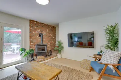 a living room with a table and a fireplace at Charming Swan Lake Apartment with Deck! in Swan Lake