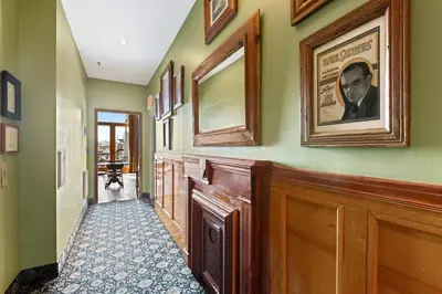 a hallway with a framed picture on the wall at The Historic Blue Moon Hotel - NYC in New York