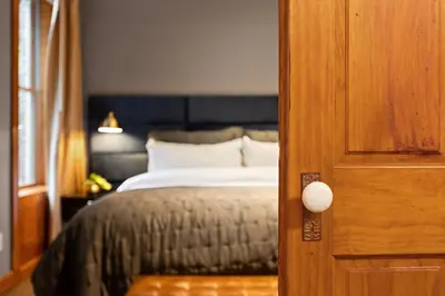a bedroom with a bed and a wooden door at The Historic Blue Moon Hotel - NYC in New York