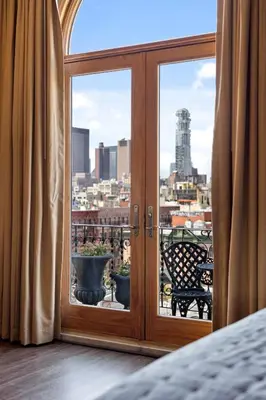 a glass door with a view of a city at The Historic Blue Moon Hotel - NYC in New York