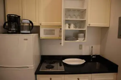 a small kitchen with a stove and a refrigerator at Hansem stay near Empire State Building in New York