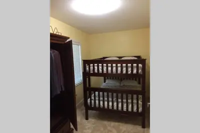 a room with a bunk bed in a room at Large family house on the lake in Hewitt