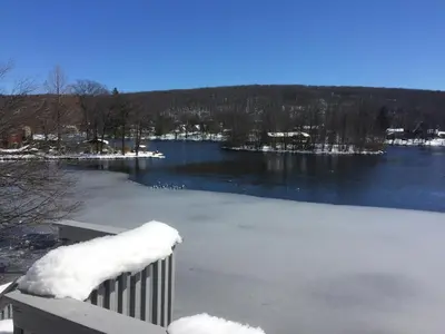 a large frozen lake with snow on top of it at Large family house on the lake in Hewitt