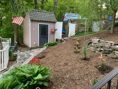 a garden with a small pink dog house at Large family house on the lake in Hewitt