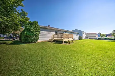 a house with a deck on the side of a yard at 12 Mi to Hersheypark Family Home with Deck! in Harrisburg