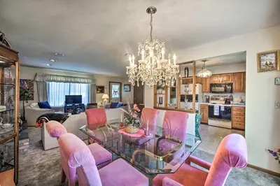 a living room with a glass table and pink chairs at 12 Mi to Hersheypark Family Home with Deck! in Harrisburg