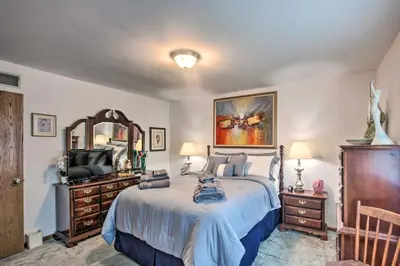 a bedroom with a bed and a mirror and a television at 12 Mi to Hersheypark Family Home with Deck! in Harrisburg