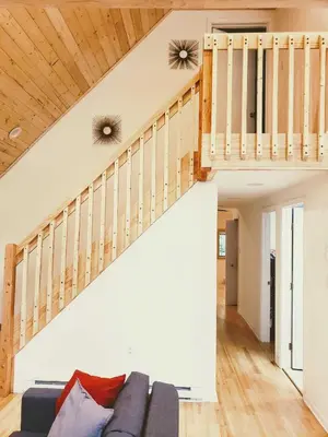 a living room with a couch and a staircase at Sheshequin in Thornhurst