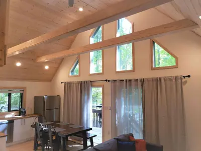 a kitchen and dining room with a table and some windows at Sheshequin in Thornhurst