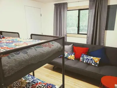 a bedroom with a bunk bed and a couch with pillows at Sheshequin in Thornhurst