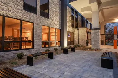 a brick building with benches in front of it at Best Western Plus Meadowlands in Secaucus