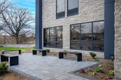 a building with benches in front of a building at Best Western Plus Meadowlands in Secaucus