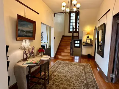 a living room with a table and a hallway at City House Bed and Breakfast in Harrisburg