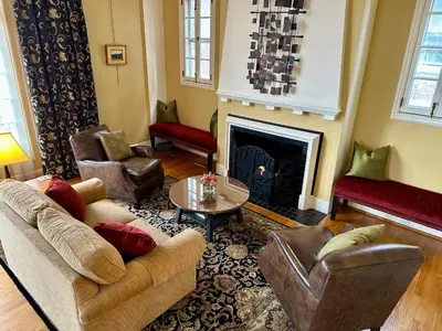 a living room with couches chairs and a fireplace at City House Bed and Breakfast in Harrisburg