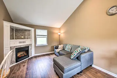 a living room with a couch and a fireplace at Family-Friendly Coatesville House with Fire Pit in Coatesville