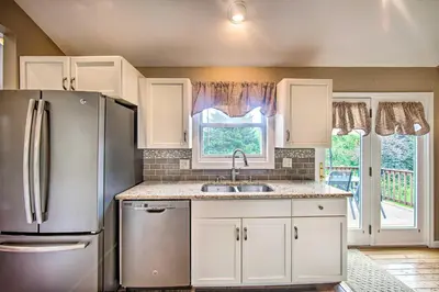 a kitchen with a refrigerator and a sink at Family-Friendly Coatesville House with Fire Pit in Coatesville