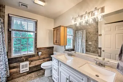 a bathroom with a sink and a toilet and a window at Family-Friendly Coatesville House with Fire Pit in Coatesville