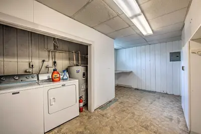 an empty kitchen with a stove and a refrigerator at Family-Friendly Coatesville House with Fire Pit in Coatesville