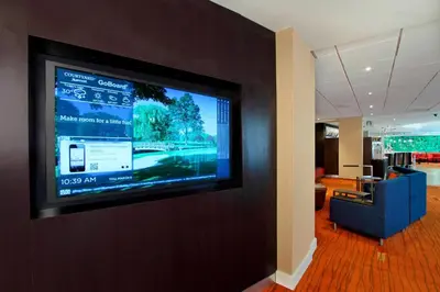 a flat screen tv hanging on a wall at Courtyard by Marriott Lyndhurst/Meadowlands in Lyndhurst