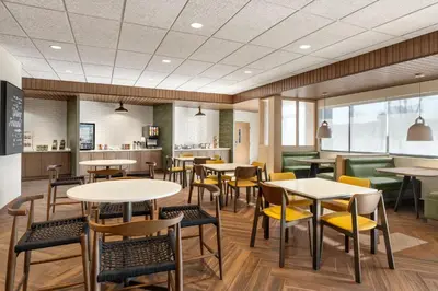 a restaurant with tables and chairs and a cafeteria at Fairfield by Marriott Inn & Suites Rockaway in Rockaway