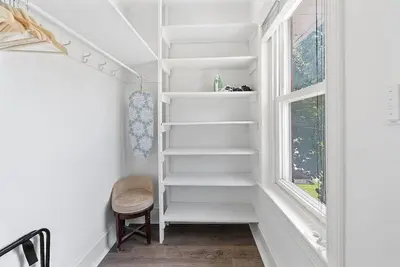 a white staircase in a room with a window at King,Parking,AC,Deck,Train,Uni,Hospital in Bryn Mawr