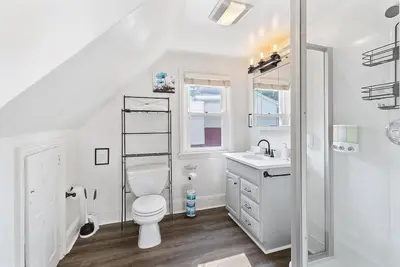 a white bathroom with a toilet and a sink at King,Parking,AC,Deck,Train,Uni,Hospital in Bryn Mawr
