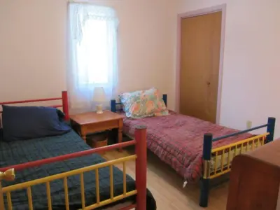 a bedroom with two beds and a table and a window at Cozy Pocono Cottage near Jack Frost Jim Thorpe in Albrightsville