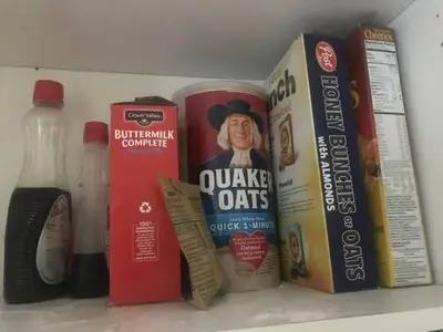 a shelf with books and other food items on it at Cozy Pocono Cottage near Jack Frost Jim Thorpe in Albrightsville