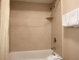a bathroom with a white tub and a sink at Super 8 by Wyndham Rahway/Newark in Rahway