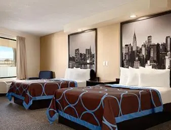 a hotel room with two beds and a large window at Super 8 by Wyndham Rahway/Newark in Rahway