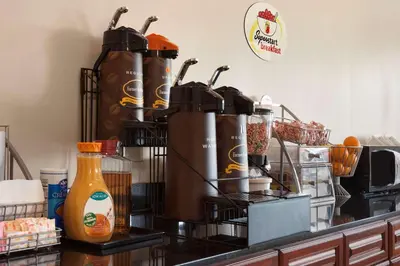 a kitchen counter with a bunch of utensils on it at Super 8 by Wyndham Rahway/Newark in Rahway