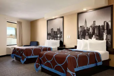 a hotel room with two beds and a large window at Super 8 by Wyndham Rahway/Newark in Rahway
