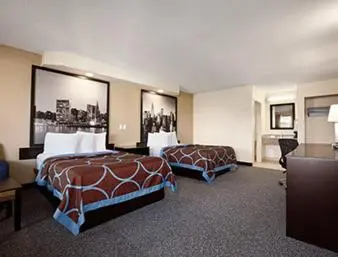 a hotel room with two beds and a desk at Super 8 by Wyndham Rahway/Newark in Rahway