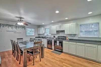 a kitchen with a table and chairs and a ceiling fan at Hot Tub and Yard Stroudsburg Home in Poconos in Stroudsburg