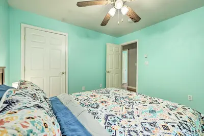 a bedroom with blue walls and a ceiling fan at Hot Tub and Yard Stroudsburg Home in Poconos in Stroudsburg