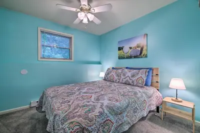a blue bedroom with a bed and a ceiling fan at Hot Tub and Yard Stroudsburg Home in Poconos in Stroudsburg