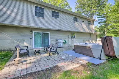 a house with a tub in front of a house at Hot Tub and Yard Stroudsburg Home in Poconos in Stroudsburg
