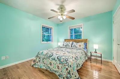 a blue bedroom with a bed and a ceiling fan at Hot Tub and Yard Stroudsburg Home in Poconos in Stroudsburg