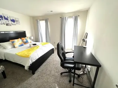 a bedroom with a bed and a desk with a chair at FREE Parking Minutes from Center City in Hilltop