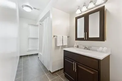 a bathroom with a sink and a mirror at FREE Parking Minutes from Center City in Hilltop