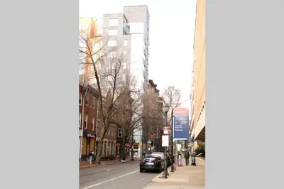 a city street with a car parked on the sidewalk at FREE Parking Minutes from Center City in Hilltop