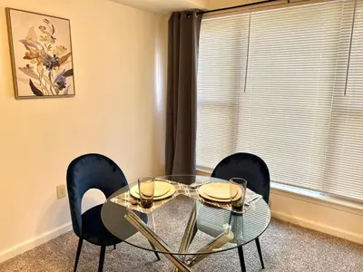 a dining room with a glass table and chairs at FREE Parking Minutes from Center City in Hilltop