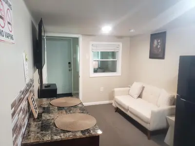 a living room with a couch and a table at The Airport Lodge in Collingdale