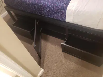 a bed with two drawers on the bottom of it at The Airport Lodge in Collingdale
