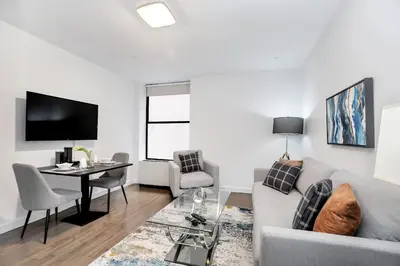 a living room with a couch and a table at National at 888 Sixth Avenue - Furnished Apartments in New York