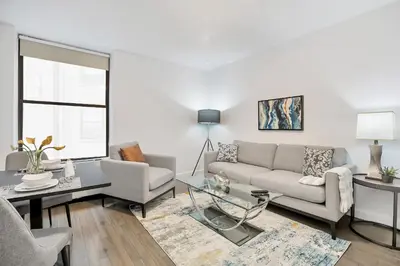 a living room with a couch and a table at National at 888 Sixth Avenue - Furnished Apartments in New York