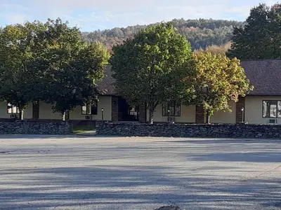 an empty street in front of a building with trees at Mountain View Lodge in Clifford
