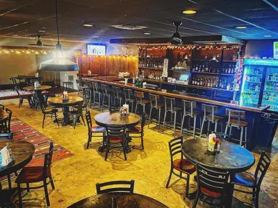 a restaurant with tables and chairs and a bar at Mountain View Lodge in Clifford