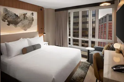 a hotel room with a bed and a large window at Hotel Indigo NYC Downtown - Wall Street by IHG in New York